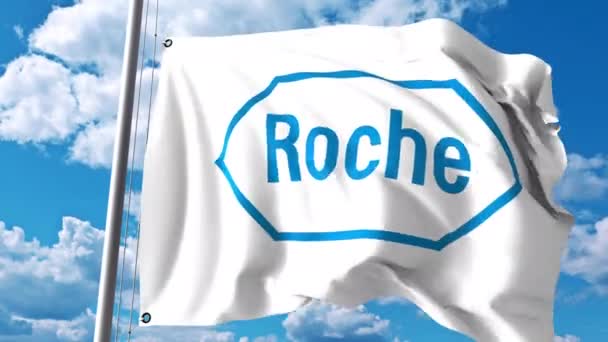 Bandera ondeando con el logotipo de Hoffmann-La Roche contra nubes y cielo. Animación editorial 4K — Vídeo de stock