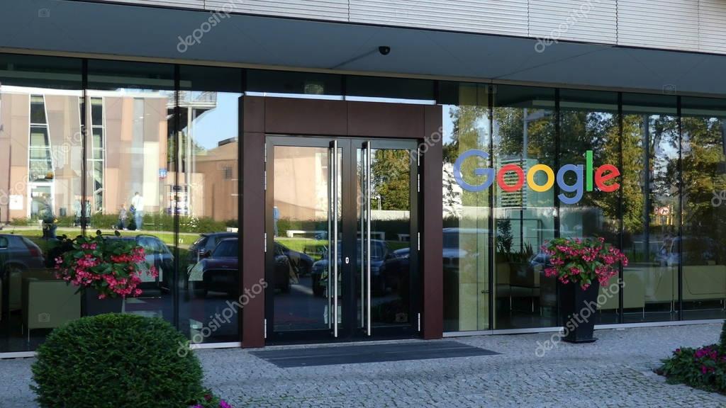 Outdoor signage board with Google logo. Modern office building. Editorial 3D