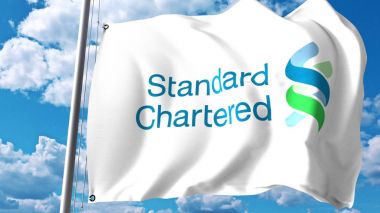 Waving flag with Standard Chartered logo against clouds and sky. Editorial 3D rendering clipart