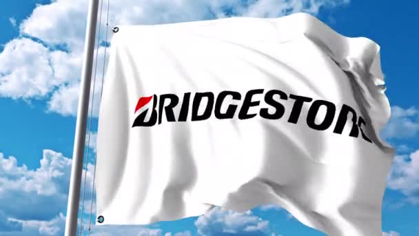 Waving flag with Bridgestone logo against clouds and sky. 4K editorial animation — Stock Video