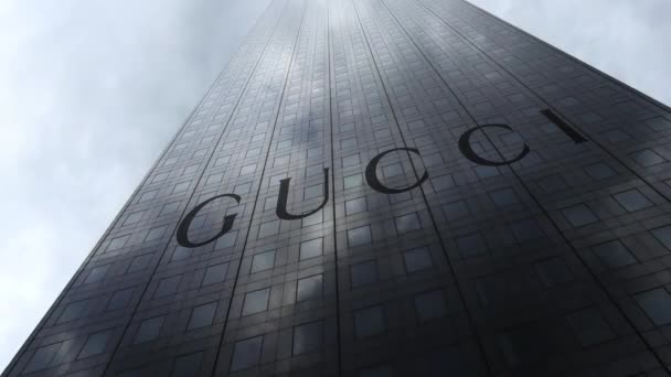 Gucci logo on a skyscraper facade reflecting clouds, time lapse. Editorial 3D rendering — Stock Video