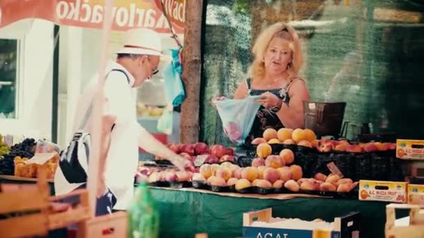 PULA, CROACIA - 4 de agosto de 2017. Mujer vendiendo melocotones en el mercado local — Vídeos de Stock
