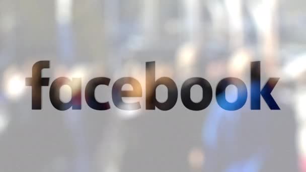 Logotipo do Facebook em um copo contra a multidão turva no steet. Renderização 3D editorial — Vídeo de Stock