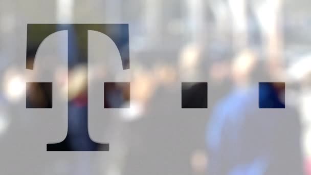 T-Mobile logo on a glass against blurred crowd on the steet. Editorial 3D rendering — Stock Video