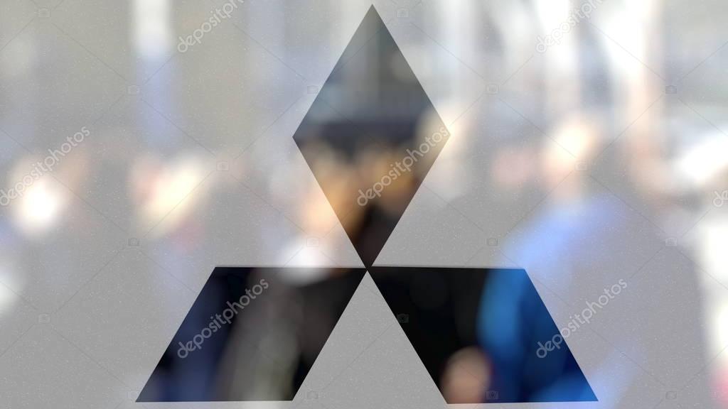 Mitsubishi logo on a glass against blurred crowd on the steet. Editorial 3D