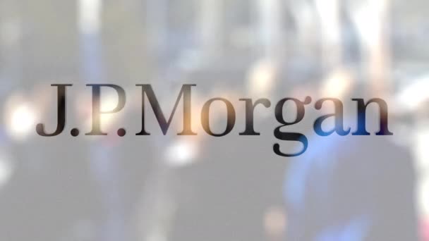 Логотип Джей Пи Моргана на стакане против размытой толпы на стите. Редакционная 3D рендеринг — стоковое видео