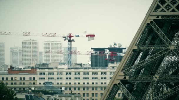 ПАРИЖ, ФРАНЦИЯ - 7 октября 2017 года. Деталь Эйфелевой башни и кранов на дальней стройке — стоковое видео