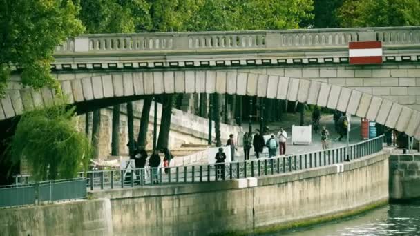 PARIS, FRANCE - OCTOBER 8, 2017. A bridge over the Seine river and pedestrian embankment — Stock Video