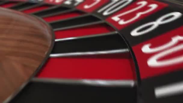 Casino roulette wheel ball hits 12 twelve red — Stock Video