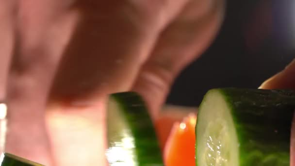 Man snijden komkommer voor plantaardige salade. Extreme close-up shot — Stockvideo