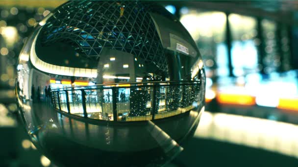 Okända människor gå i en modern shoppinggalleria, Visa genom glas bollen — Stockvideo