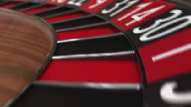 Casino roulette wheel ball hits 4 four black — Stock Video