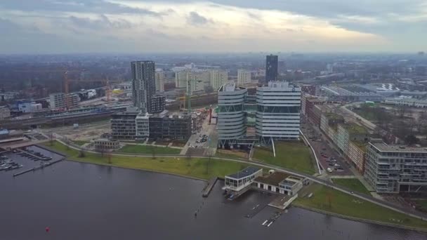 AMSTERDAM, PAÍSES BAJOS - 29 DE DICIEMBRE DE 2017. Vista aérea del distrito de De Omval, el río Amstel y la estación de metro de Spaklerweg — Vídeos de Stock