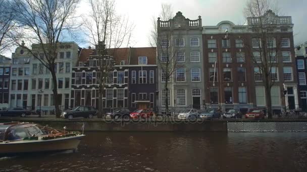 AMSTERDAM, NETHERLANDS - DECEMBER 26, 2017. Boat sightseeing tour on city canal — Stock Video