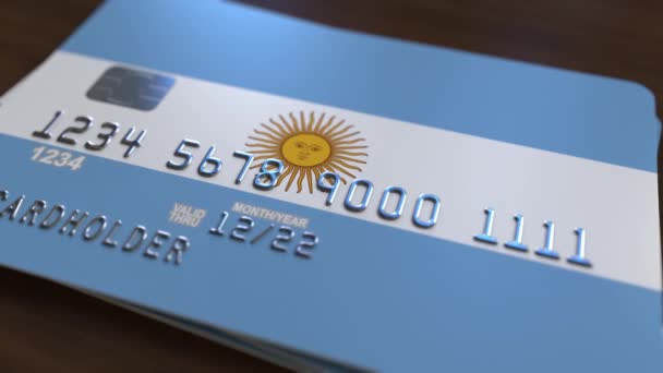 Plastic bank card featuring flag of Argentina. National banking system related animation — Stock Video