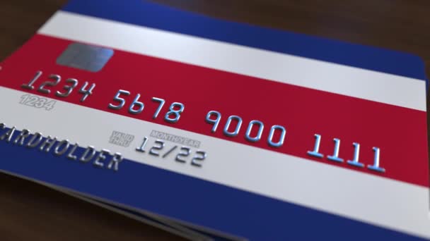 Plastic bank card featuring flag of Costa Rica. National banking system related animation — Stock Video