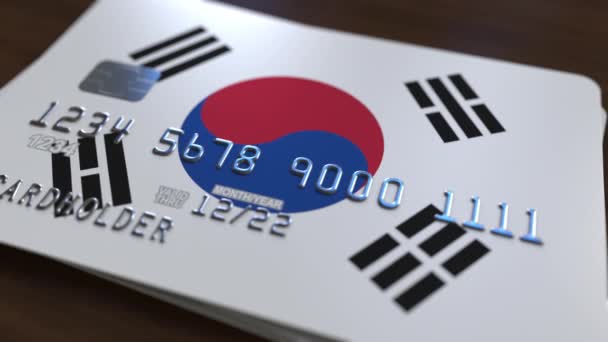 Plástico cartão bancário com bandeira da Coreia do Sul. Animação relacionada com o sistema bancário nacional — Vídeo de Stock