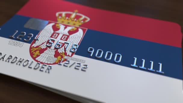 Plastic bank card featuring flag of Serbia. National banking system related animation — Stock Video