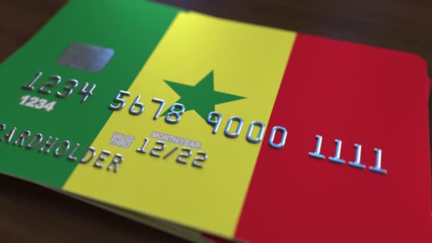 Tarjeta bancaria de plástico con bandera de Senegal. Animación relacionada con el sistema bancario nacional — Vídeos de Stock