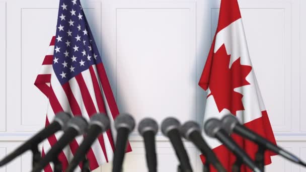 Bandeiras dos EUA e Canadá em reunião internacional ou negociações conferência de imprensa — Vídeo de Stock