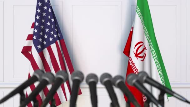Flags of the USA and Iran at international meeting or negotiations press conference — Stock Video