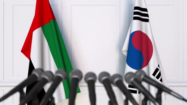 Flags of the UAE and Korea at international meeting or negotiations press conference — Stock Video