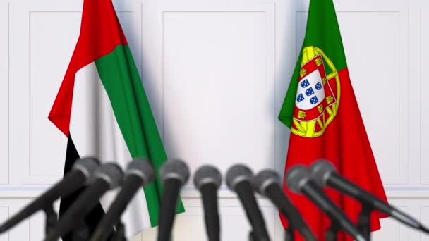 Flags of the UAE and Portugal at international meeting or negotiations press conference — Stock Video