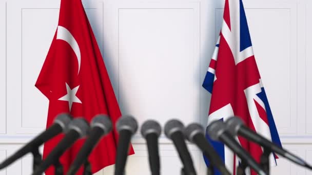 Drapelele Turciei și Marii Britanii la o întâlnire internațională sau la o conferință de presă — Videoclip de stoc