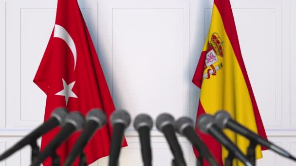 Flags of Turkey and Spain at international meeting or negotiations press conference — Stock Video