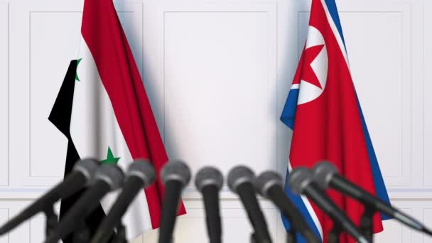 Flags of Syria and North Korea at international meeting or negotiations press conference — Stock Video