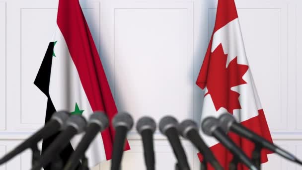 국제 회의 또는 협상 기자 회견에서 시리아와 캐나다의 깃발 — 비디오