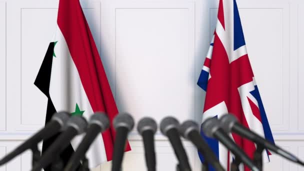 Banderas de Siria y el Reino Unido en la reunión internacional o en la conferencia de prensa de negociaciones — Vídeos de Stock