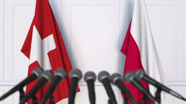 瑞士和波兰在国际会议或谈判新闻发布会上的旗帜 — 图库视频影像