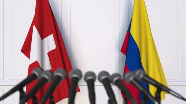 Flags of Switzerland and Colombia at international meeting or negotiations press conference — Stock Video