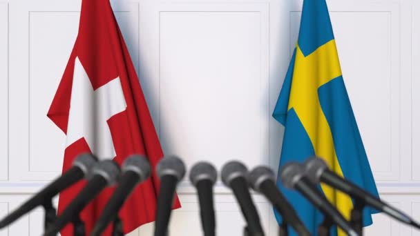 瑞士和瑞典国旗在国际会议或谈判新闻发布会上 — 图库视频影像