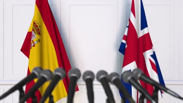 Flags of Spain and The United Kingdom at international meeting or negotiations press conference — Stock Video