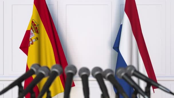 Flags of Spain and Netherlands at international meeting or negotiations press conference — Stock Video