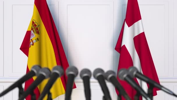 Flags of Spain and Denmark at international meeting or negotiations press conference — Stock Video