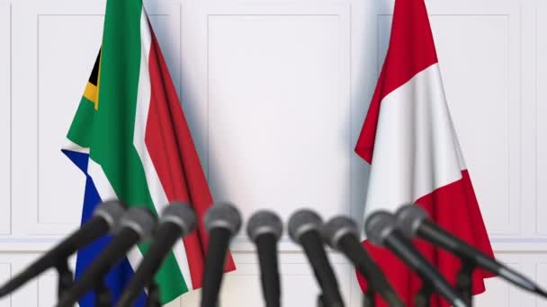 Flags of South Africa and Peru at international meeting or negotiations press conference — Stock Video