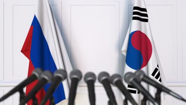 Flags of Russia and South Korea at international meeting or negotiations press conference — Stock Video