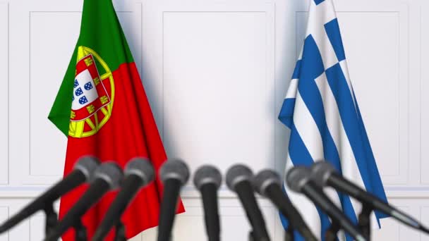 Flags of Portugal and Greece at international meeting or negotiations press conference — Stock Video