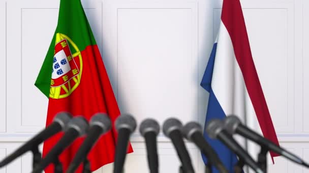 Flags of Portugal and Netherlands at international meeting or negotiations press conference — Stock Video