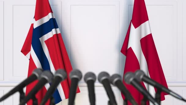 Flags of Norway and Denmark at international meeting or negotiations press conference — Stock Video