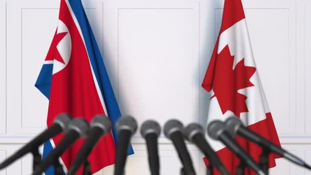 Bandiere della Corea del Nord e del Canada alla riunione internazionale o alla conferenza stampa dei negoziati — Video Stock