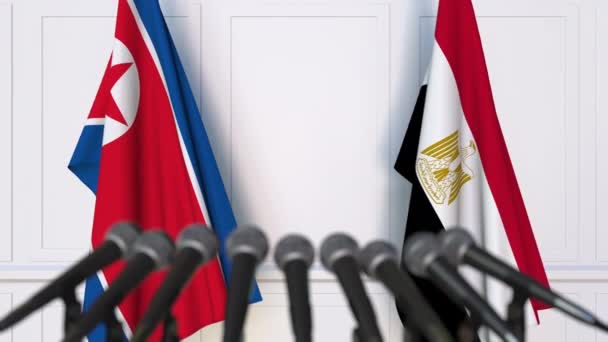 Flags of North Korea and Egypt at international meeting or negotiations press conference — Stock Video