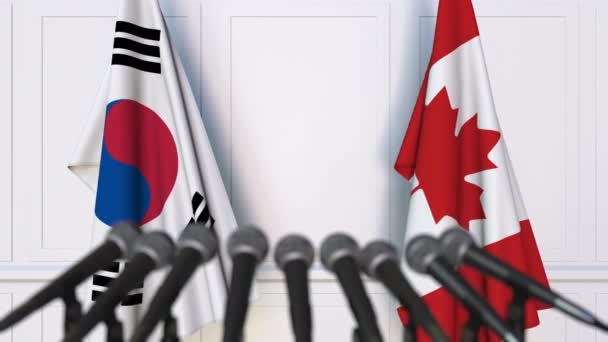 Güney Kore ve Kanada bayrakları Uluslararası Toplantı veya anlaşmalarını basın toplantısında — Stok video