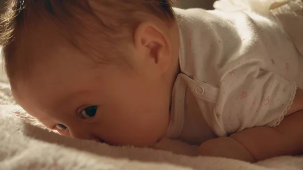 Meisje van de baby proberen te kruipen op het bed — Stockfoto