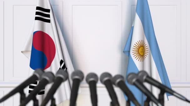 Flags of South Korea and Argentina at international meeting or negotiations press conference — Stock Video