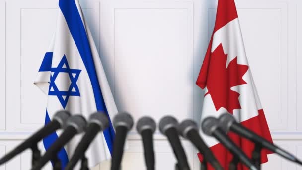 Flags of Israel and Canada at international meeting or negotiations press conference — Stock Video