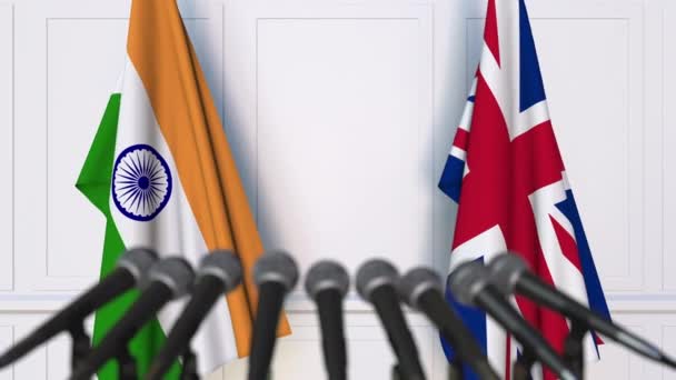 Flags of India and The United Kingdom at international meeting or negotiations press conference — Stock Video